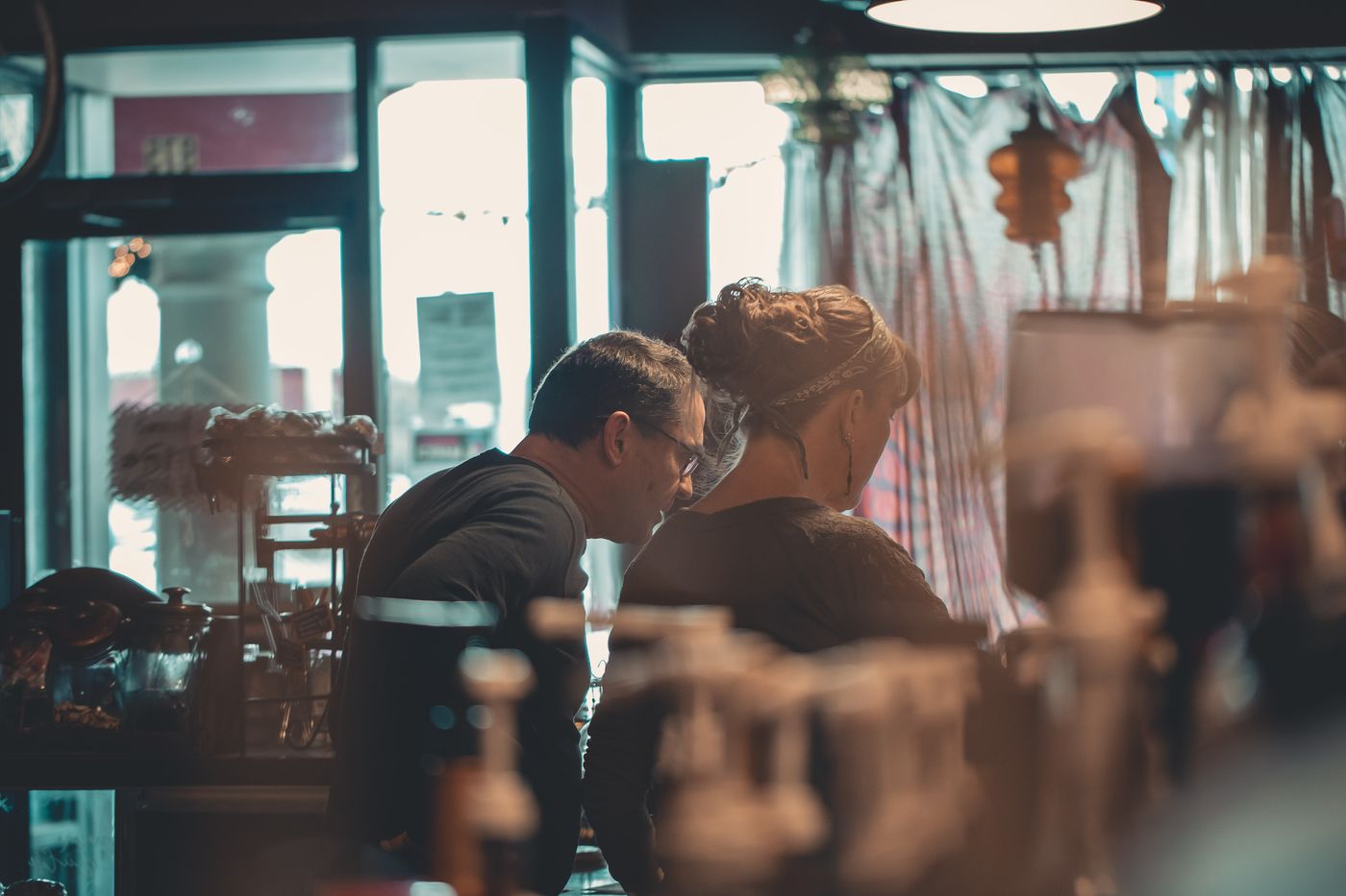 Two business partners talking inside their shop