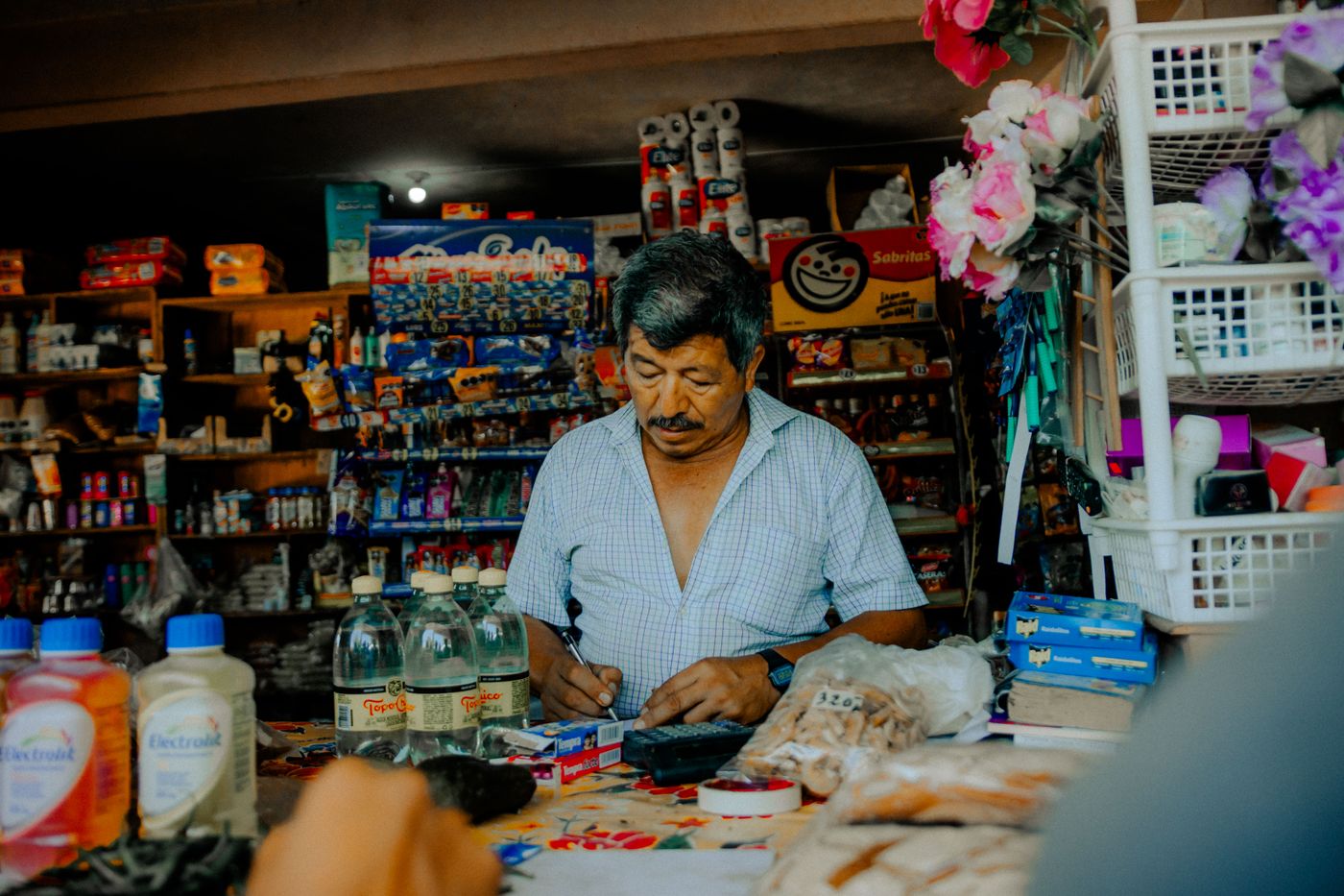 Shopkeeper serving a customer in a grocery store